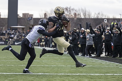 Nov 19, 2022; West Lafayette, Indiana, USA;  Purdue Boilermakers tight end Payne Durham (87) catches a pass that results in a touchdown against Northwestern Wildcats defensive back Jeremiah Lewis (9) during the second quarter  at Ross-Ade Stadium. Mandatory Credit: Marc Lebryk-USA TODAY Sports