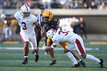 Nov 19, 2022; Berkeley, California, USA; California Golden Bears wide receiver Mavin Anderson (11) runs after a catch against Stanford Cardinal linebacker Levani Damuni (3) and safety Alaka'i Gilman (33) during the second quarter at FTX Field at California Memorial Stadium. Mandatory Credit: Darren Yamashita-USA TODAY Sports