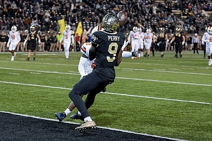 Nov 19, 2022; Winston-Salem, North Carolina, USA; Wake Forest Demon Deacons wide receiver A.T. Perry (9) makes a catch against Syracuse Orange defensive back Darian Chestnut (0) to score during the first half at Truist Field. Mandatory Credit: Jim Dedmon-USA TODAY Sports
