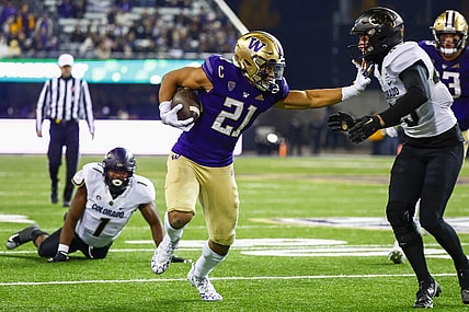 Nov 19, 2022; Seattle, Washington, USA; Washington Huskies running back Wayne Taulapapa (21) stiff arms against Colorado Buffaloes safety Trevor Woods (43) during the second quarter at Alaska Airlines Field at Husky Stadium. Mandatory Credit: Joe Nicholson-USA TODAY Sports