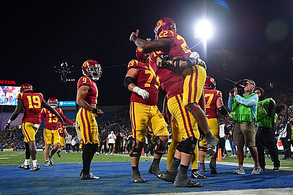 Nov 19, 2022; Pasadena, California, USA; Southern California Trojans running back Darwin Barlow (22) celebrates his touchdown scored against the UCLA Bruins with offensive lineman Bobby Haskins (70) during the second half at the Rose Bowl. Mandatory Credit: Gary A. Vasquez-USA TODAY Sports