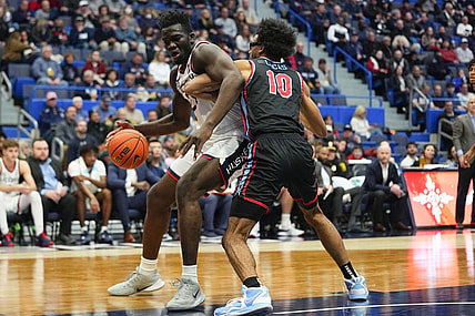 Nov 20, 2022; Hartford, Connecticut, USA; Connecticut Huskies forward Adama Sanogo (21) dribbles the ball against Delaware State Hornets forward Ronald Lucas (10) during the second half at XL Center. Mandatory Credit: Gregory Fisher-USA TODAY Sports