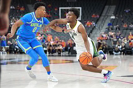 Nov 20, 2022; Las Vegas, Nevada, USA; Baylor Bears guard LJ Cryer (4) dribbles against UCLA Bruins guard Jaylen Clark (0) during the second half at T-Mobile Arena. Mandatory Credit: Stephen R. Sylvanie-USA TODAY Sports