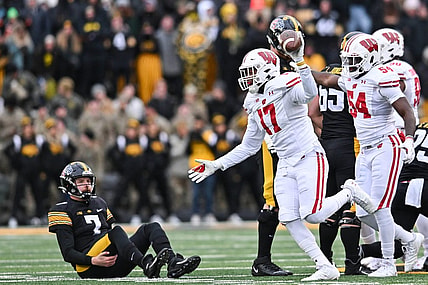 Nov 12, 2022; Iowa City, Iowa, USA; Wisconsin Badgers linebacker Darryl Peterson (17) and linebacker Jordan Turner (54) react as Iowa Hawkeyes quarterback Spencer Petras (7) looks on during the game at Kinnick Stadium. Mandatory Credit: Jeffrey Becker-USA TODAY Sports