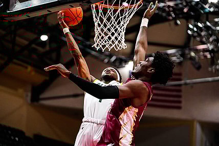 Nov 24, 2022; Orlando, FL, USA; Siena Saints guard Jared Billups (1) shoots as Florida State Seminoles center Naheem McLeod (24) attempts to block during the first half at ESPN Wide World of Sports. Mandatory Credit: Rich Storry-USA TODAY Sports