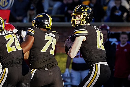Nov 25, 2022; Columbia, Missouri, USA; Missouri Tigers quarterback Brady Cook (12) drops to throw against the Arkansas Razorbacks during the first half at Faurot Field at Memorial Stadium. Mandatory Credit: Denny Medley-USA TODAY Sports