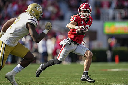 Nov 26, 2022; Athens, Georgia, USA; Georgia Bulldogs quarterback Stetson Bennett (13) runs with the ball against the Georgia Tech Yellow Jackets during the first quarter at Sanford Stadium. Mandatory Credit: Dale Zanine-USA TODAY Sports