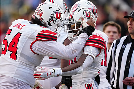 Nov 26, 2022; Boulder, Colorado, USA; Utah Utes wide receiver Money Parks (10) is congratulated for his touchdown by Utah Utes offensive lineman Paul Maile (54) in the second quarter at Folsom Field. Mandatory Credit: Ron Chenoy-USA TODAY Sports