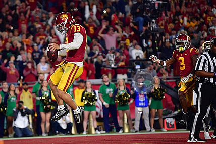 Nov 26, 2022; Los Angeles, California, USA; Southern California Trojans quarterback Caleb Williams (13) scores a touchdown against the Notre Dame Fighting Irish during the first half at the Los Angeles Memorial Coliseum. Mandatory Credit: Gary A. Vasquez-USA TODAY Sports