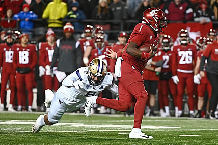 Nov 26, 2022; Pullman, Washington, USA; Washington State Cougars quarterback Cameron Ward (1) is caught from behind by Washington Huskies defensive lineman Bralen Trice (8) in first half at Gesa Field at Martin Stadium. Mandatory Credit: James Snook-USA TODAY Sports