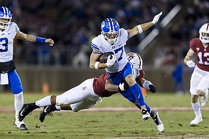 Nov 26, 2022; Stanford, California, USA;  Brigham Young Cougars wide receiver Chase Roberts (27) runs the ball against Stanford Cardinal defensive end Aeneas DiCosmo (0) during the first half at Stanford Stadium. Mandatory Credit: John Hefti-USA TODAY Sports