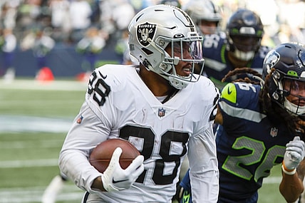 Nov 27, 2022; Seattle, Washington, USA; Las Vegas Raiders running back Josh Jacobs (28) rushes fora touchdown against the Seattle Seahawks during the second quarter at Lumen Field. Mandatory Credit: Joe Nicholson-USA TODAY Sports