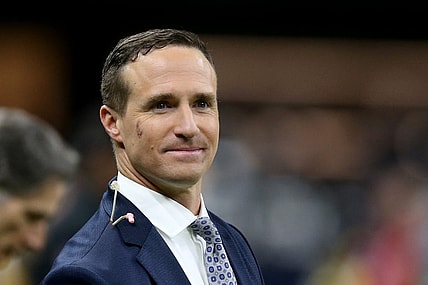 Nov 25, 2021; New Orleans, Louisiana, USA; Former New Orleans Saints quarterback Drew Brees stands on the sidelines before the game between the New Orleans Saints and the Buffalo Bills at the Caesars Superdome. Brees is b being honored at half-time of the game that he is also announcing for NBC. Mandatory Credit: Chuck Cook-USA TODAY Sports