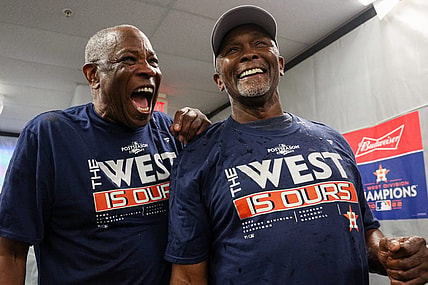 Sep 19, 2022; St. Petersburg, Florida, USA;  Houston Astros manager Dusty Baker Jr. (12) and third base coach Gary Pettis (8) celebrate winning the American League West at Tropicana Field. Mandatory Credit: Nathan Ray Seebeck-USA TODAY Sports