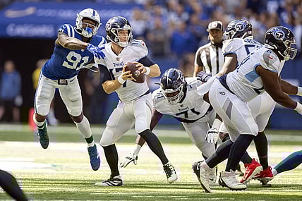 Oct 2, 2022; Indianapolis, Indiana, USA;  Tennessee Titans quarterback Ryan Tannehill (17) narrowly misses being sacked by Indianapolis Colts defensive end Yannick Ngakoue (91) during the first quarter at Lucas Oil Stadium. Mandatory Credit: Marc Lebryk-USA TODAY Sports