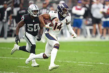 Oct 2, 2022; Paradise, Nevada, USA; Denver Broncos wide receiver Courtland Sutton (14) runs with the ball ahead of Las Vegas Raiders linebacker Jayon Brown (50) during a game at Allegiant Stadium. Mandatory Credit: Stephen R. Sylvanie-USA TODAY Sports