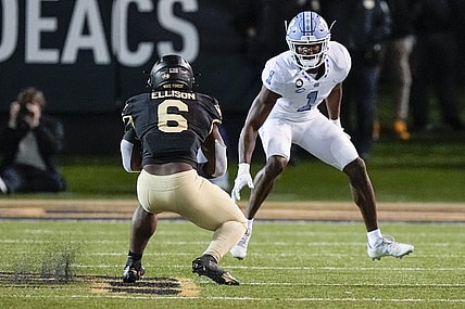 Nov 12, 2022; Winston-Salem, North Carolina, USA;  Wake Forest Demon Deacons running back Justice Ellison (6) tries to evade North Carolina Tar Heels defensive back Tony Grimes (1) during the second half at Truist Field. Mandatory Credit: Jim Dedmon-USA TODAY Sports