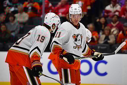 Nov 15, 2022; Anaheim, California, USA; Anaheim Ducks center Trevor Zegras (11) speaks with right wing Troy Terry (19) during the second period at Honda Center. Mandatory Credit: Gary A. Vasquez-USA TODAY Sports