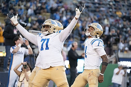 November 25, 2022; Berkeley, California, USA; UCLA Bruins offensive lineman Raiqwon O'Neal (71) and quarterback Dorian Thompson-Robinson (1) celebrate a two-point conversion against the California Golden Bears during the fourth quarter at California Memorial Stadium. Mandatory Credit: Kyle Terada-USA TODAY Sports
