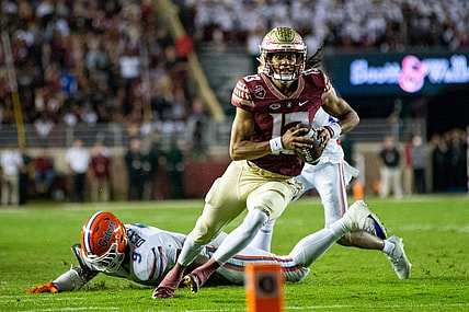 Florida State Seminoles quarterback Jordan Travis (13) eyes the end zone as he runs down the field. The Florida State Seminoles defeated the Florida Gators 45-38 at Doak Campbell Stadium on Friday, Nov. 25, 2022.

Fsu V Uf First Half1485