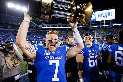Nov 26, 2022; Lexington, Kentucky, USA; Kentucky Wildcats quarterback Will Levis (7) holds up the Governor   s Cup trophy after winning the game against the Louisville Cardinals at Kroger Field. Mandatory Credit: Jordan Prather-USA TODAY Sports