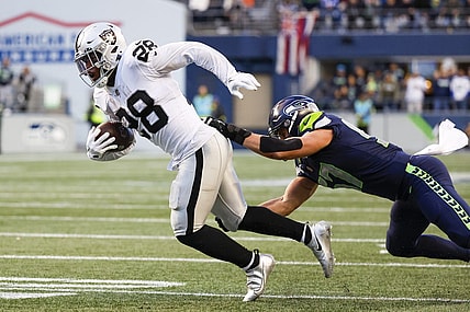 Nov 27, 2022; Seattle, Washington, USA; Las Vegas Raiders running back Josh Jacobs (28) breaks a tackle attempt by Seattle Seahawks linebacker Cody Barton (57) after making a reception during the fourth quarter at Lumen Field. Mandatory Credit: Joe Nicholson-USA TODAY Sports