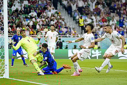 Nov 29, 2022; Doha, Qatar; United States of America forward Christian Pulisic (10) collides with Iran goalkeeper Alireza Beiranvand (1) after scoring a goal during the first half of a group stage during the 2022 World Cup at Al Thumama Stadium. Mandatory Credit: Danielle Parhizkaran-USA TODAY Sports