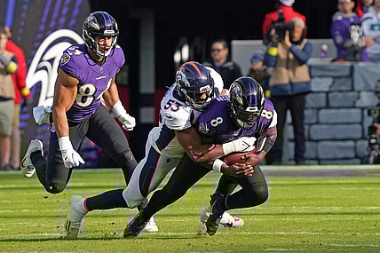 Dec 4, 2022; Baltimore, Maryland, USA; Baltimore Ravens quarterback Lamar Jackson (8) would leave the game after being sacked in the second quarter by Denver Broncos linebacker Jonathon Cooper (53) at M&T Bank Stadium. Mandatory Credit: Mitch Stringer-USA TODAY Sports