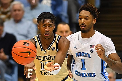 Dec 10, 2022; Chapel Hill, North Carolina, USA; Georgia Tech Yellow Jackets guard Miles Kelly (13) passes the ball as North Carolina Tar Heels forward Leaky Black (1) defends in the second half at Dean E. Smith Center. Mandatory Credit: Bob Donnan-USA TODAY Sports