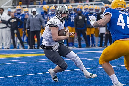 Dec 20, 2022; Boise, Idaho, USA; Eastern Michigan Eagles quarterback Taylor Powell (7) runs for a first down during the first half of action of the Famous Idaho Potato Bowl against the San Jose State Spartans at Albertsons Stadium. Mandatory Credit: Brian Losness-USA TODAY Sports