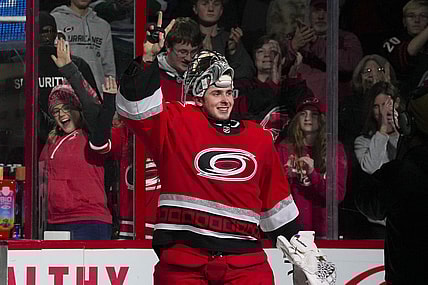 Dec 20, 2022; Raleigh, North Carolina, USA;  Carolina Hurricanes goaltender Pyotr Kochetkov (52) celebrates their victory after the game against the New Jersey Devils at PNC Arena. Mandatory Credit: James Guillory-USA TODAY Sports