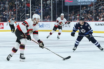Dec 20, 2022; Winnipeg, Manitoba, CAN; Ottawa Senators forward Tyler Motte (14) skates away from Winnipeg Jets forward Cole Perfetti (91) during the first period at Canada Life Centre. Mandatory Credit: Terrence Lee-USA TODAY Sports