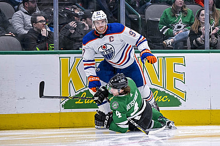 Dec 21, 2022; Dallas, Texas, USA; Edmonton Oilers center Connor McDavid (97) checks Dallas Stars defenseman Miro Heiskanen (4) during the first period at the American Airlines Center. Mandatory Credit: Jerome Miron-USA TODAY Sports
