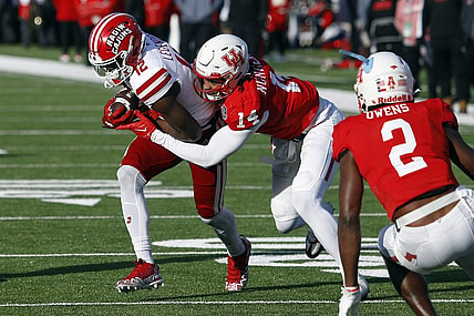 Dec 23, 2022; Shreveport, Louisiana, USA; Louisiana-Lafayette Ragin' Cajuns wide receiver Lance Legendre (12) runs after a catch as Houston Cougars linebacker Mannie Nunnery (14) makes the tackle during the first half in the 2022 Independence Bowl at Independence Stadium. Mandatory Credit: Petre Thomas-USA TODAY Sports