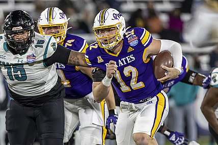 Dec 27, 2022; Birmingham, Alabama, USA; East Carolina Pirates quarterback Holton Ahlers (12) runs the ball against the Coastal Carolina Chanticleers in the 2022 Birmingham Bowl at Protective Stadium. Mandatory Credit: Vasha Hunt-USA TODAY Sports