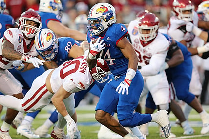 Dec 28, 2022; Memphis, TN, USA; Kansas Jayhawks running back Devin Neal (4) rushes against the Arkansas Razorbacks in the first quarter in the 2022 Liberty Bowl at Liberty Bowl Memorial Stadium. Mandatory Credit: Nelson Chenault-USA TODAY Sports