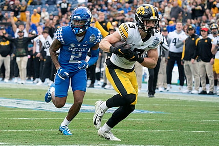 Iowa defensive back Cooper DeJean (3) pulls in an interception for a touchdown over Kentucky wide receiver Barion Brown (2) during the second quarter of the TransPerfect Music City Bowl at Nissan Stadium Saturday, Dec. 31, 2022, in Nashville, Tenn.

Ncaa Football Music City Bowl Iowa At Kentucky