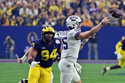 Dec 31, 2022; Glendale, Arizona, USA; TCU Horned Frogs quarterback Max Duggan (15) passes against Michigan Wolverines defensive lineman Kris Jenkins (94) in the second quarter of the 2022 Fiesta Bowl at State Farm Stadium. Mandatory Credit: Matt Kartozian-USA TODAY Sports