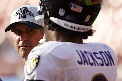 Aug 28, 2021; Landover, Maryland, USA; Baltimore Ravens head coach John Harbaugh (L) talks with Ravens quarterback Lamar Jackson (8) during warmups prior to their game against the Washington Football Team at FedExField. Mandatory Credit: Geoff Burke-USA TODAY Sports