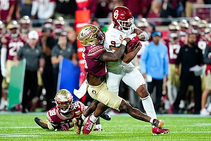 Dec 29, 2022; Orlando, Florida, USA; Florida State Seminoles defensive back Jammie Robinson (10) tackles Oklahoma Sooners tight end Brayden Willis (9) during the second half in the 2022 Cheez-It Bowl at Camping World Stadium. Mandatory Credit: Rich Storry-USA TODAY Sports