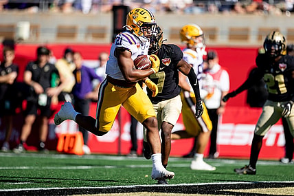 Jan 2, 2023; Orlando, FL, USA; LSU Tigers running back Noah Cain (21) rushes for a touchdown during the first half against the Purdue Boilermakers at Camping World Stadium. Mandatory Credit: Matt Pendleton-USA TODAY Sports