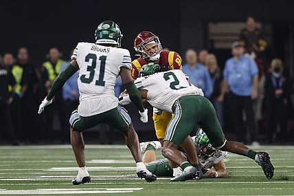 Jan 2, 2023; Arlington, Texas, USA; USC Trojans wide receiver Kyle Ford (81) is tackled by Tulane Green Wave linebacker Dorian Williams (2) in the second quarter in the 2023 Cotton Bowl at AT&T Stadium. Mandatory Credit: Tim Heitman-USA TODAY Sports