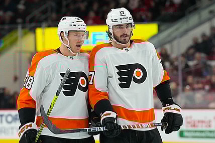 Dec 23, 2022; Raleigh, North Carolina, USA;  Philadelphia Flyers center Patrick Brown (38) and center Zack MacEwen (17) talk against the Carolina Hurricanes during the second period at PNC Arena. Mandatory Credit: James Guillory-USA TODAY Sports