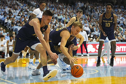 Jan 7, 2023; Chapel Hill, North Carolina, USA;  Notre Dame Fighting Irish guard Dane Goodwin (23) and forward Nate Laszewski (14) got after the loose ball against the North Carolina Tar Heels during the second half at Dean E. Smith Center. Mandatory Credit: James Guillory-USA TODAY Sports