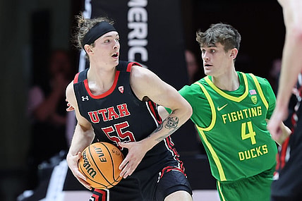 Jan 7, 2023; Salt Lake City, Utah, USA; Utah Utes guard Gabe Madsen (55) looks to pass the ball against Oregon Ducks guard Brennan Rigsby (4) in the first half at Jon M. Huntsman Center. Mandatory Credit: Rob Gray-USA TODAY Sports