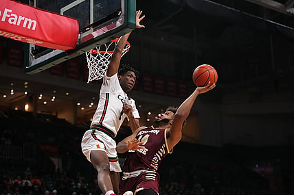 Jan 11, 2023; Coral Gables, Florida, USA; Boston College Eagles forward CJ Penha Jr. (24) shoots the ball against Miami Hurricanes forward Anthony Walker (1) during the first half at Watsco Center. Mandatory Credit: Jasen Vinlove-USA TODAY Sports