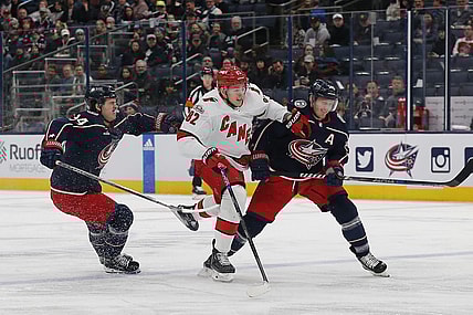 Jan 12, 2023; Columbus, Ohio, USA; Carolina Hurricanes center Jesperi Kotkaniemi (82) avoids then check from Columbus Blue Jackets center Gustav Nyquist (14) during the first period at Nationwide Arena. Mandatory Credit: Russell LaBounty-USA TODAY Sports