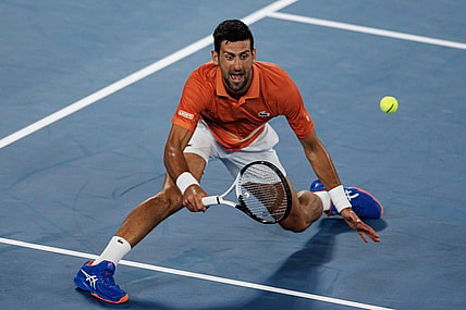 Jan 13, 2023; Melbourne, Victoria, Australia; Novak Djokovic of Serbia hits a shot during an exhibition practice match against Nick Kyrgios of Australia on Rod Laver Arena at Melbourne Park. Mandatory Credit: Mike Frey-USA TODAY Sports
