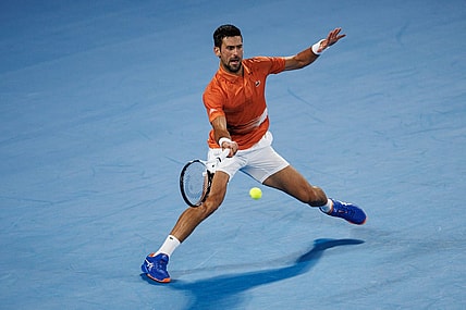 Jan 13, 2023; Melbourne, Victoria, Australia; Novak Djokovic of Serbia hits a shot during an exhibition practice match against Nick Kyrgios of Australia on Rod Laver Arena at Melbourne Park. Mandatory Credit: Mike Frey-USA TODAY Sports
