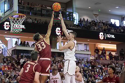 Jan 14, 2023; Charleston, South Carolina, USA; Charleston Cougars forward Ante Brzovic (10) shoots the ball over Elon Phoenix forward John Bowen III (33) in the first half at TD Arena. Mandatory Credit: David Yeazell-USA TODAY Sports